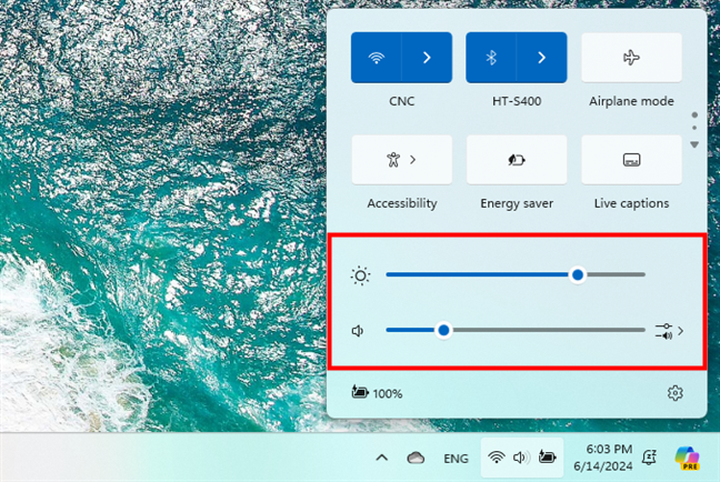 The brightness and volume sliders in the Quick Settings panel